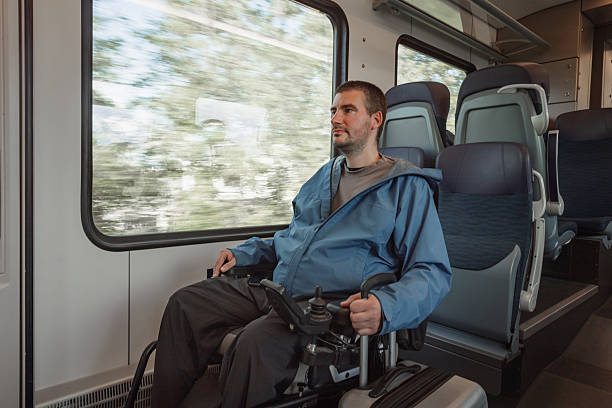 istock Man sitting in a wheelchair inside a train accessible for people with disability 2218465650