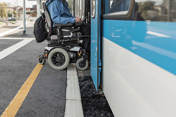 istock Man with a physical disability, an electric wheelchair user entering a train 2218465682