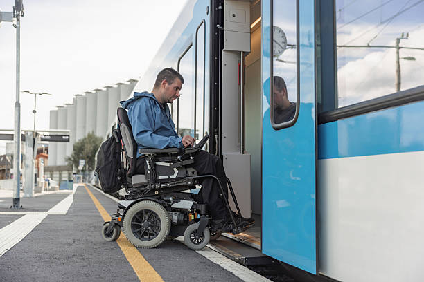 istock Man with a physical disability, an electric wheelchair user entering a train 2218465731