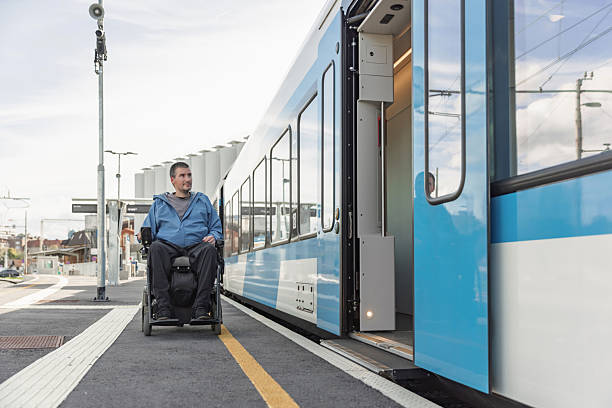 istock Man with a physical disability, an electric wheelchair user entering a train 2218465794