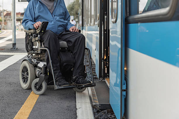 istock Man with a physical disability, an electric wheelchair user entering a train 2218465853