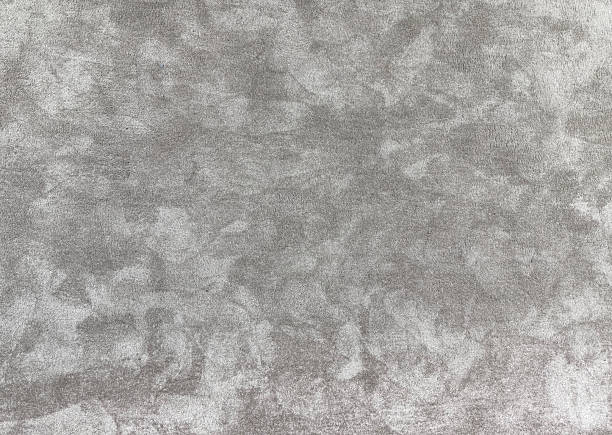 Grey crushed velvet texture close-up, soft luxurious fabric background for design. grey fluffy carpet for interior floor coveing.