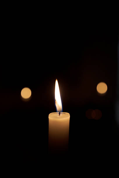 istock A candle is lit in a dark room 2218466446