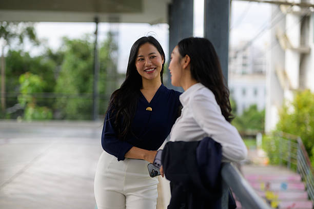 istock Two young businesswomen engaging in a lively discussion on a balcony while enjoying a stunning cityscape view 2218467041