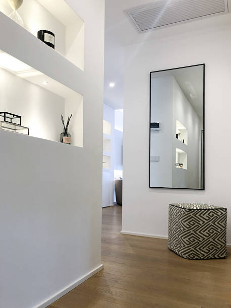 istock Stylish hallway with niche shelves, vertical mirror and patterned pouf 2218467152