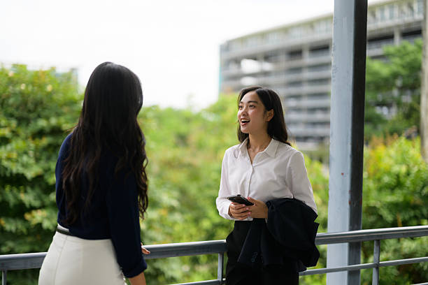istock Professional women networking during outdoor work break, discussing project details with positive energy and collaborative spirit 2218467351