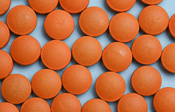 istock Many Orange pills on a blue background 2218469440