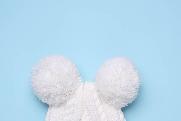 Children's warm hat with a balabons on a blue background