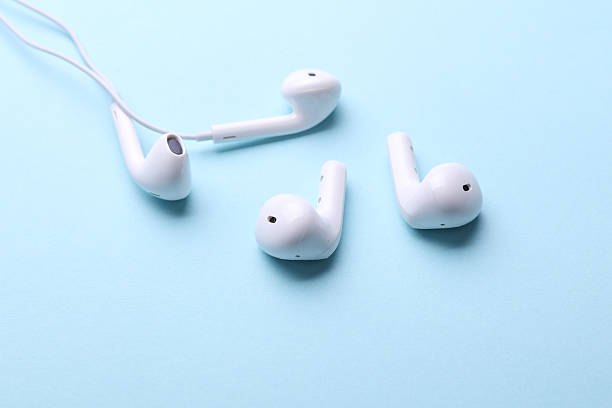 istock Wired and wirelass white earphones on a blue background 2218470907