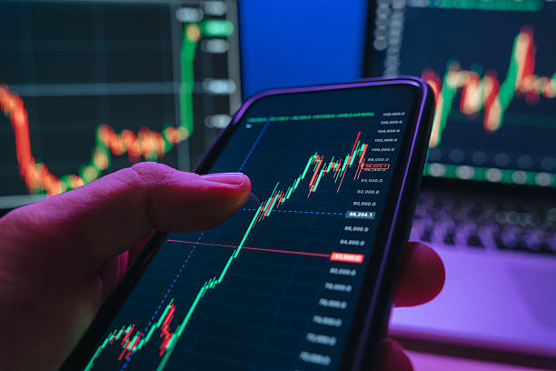 istock businessman using trading application on smartphone with stock market charts 2218471230