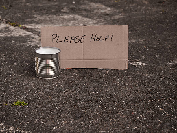 Please help sign with tin can for money donations medium shot selective focus