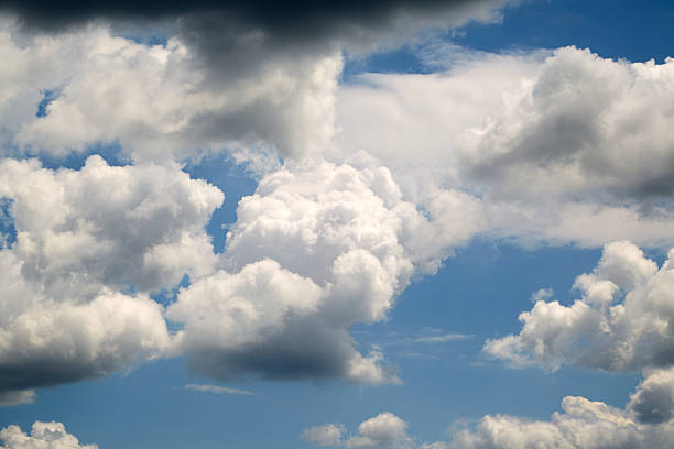 istock Multi-layered white and gray clouds in the blue sky close-up, view among clouds high in the sky, clouds up close, airy white clouds during weather change. 2218475832
