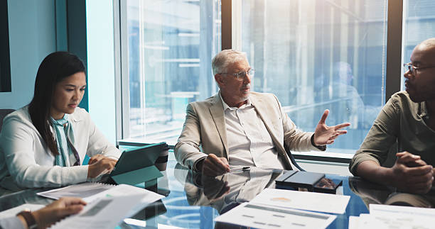 istock Meeting, collaboration and group with documents, planning and discussion for stats, team and company. Corporate, colleagues and analysis of charts in business, people and communication for updates 2218477068