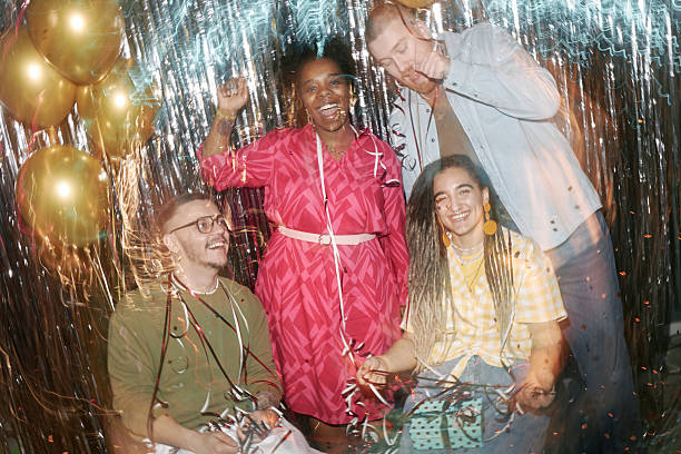 Group of Smiling Friends Creating Circle and Looking Down