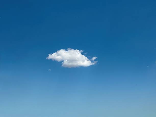 Cloud, one single white and fluffy on blue sky, sunny spring day.