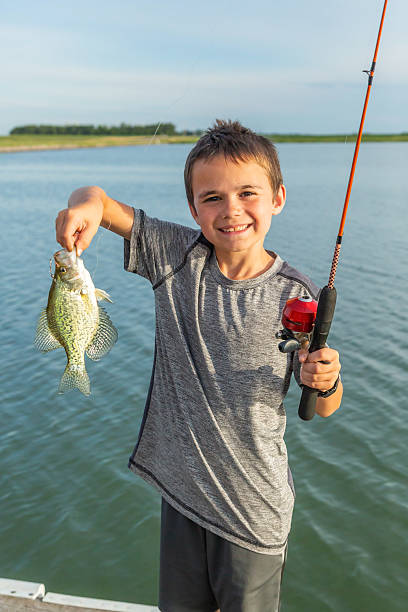 istock Boy Holding Crappie He Caught While Fishing 2218479082