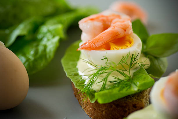 Delicious toast with salad, shrimp and boiled egg.
