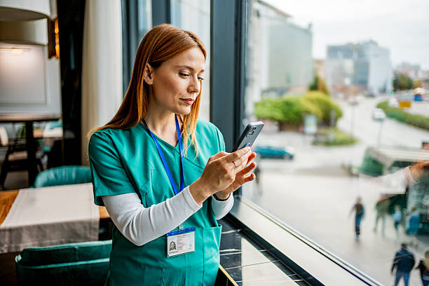 istock Nurse using smartphone during break in hospital cafeteria 2218483572