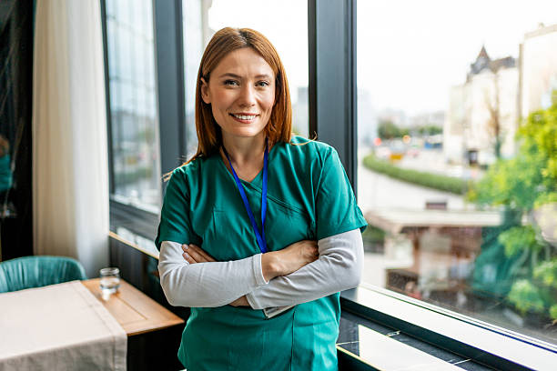 istock Confident nurse smiling with crossed arms by the window 2218483592
