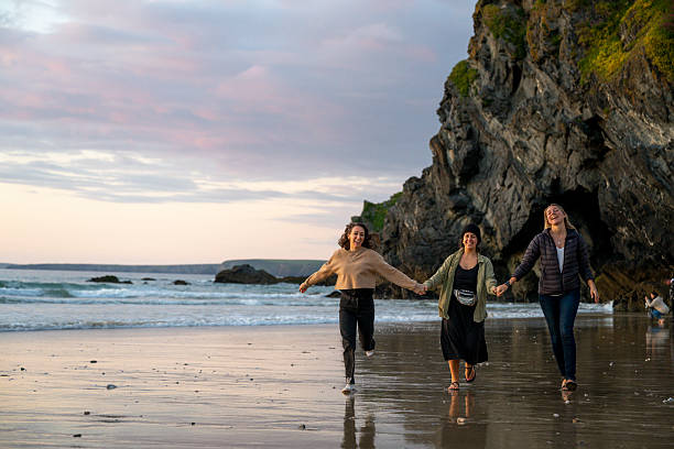 istock Friends have fun on beach at sunset, Cornwall 2218483622