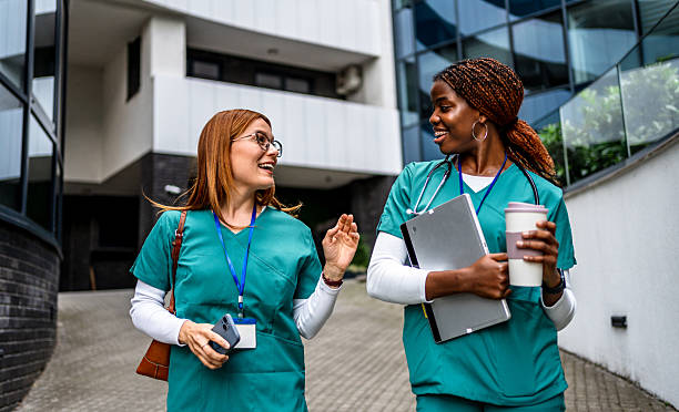 istock Two nurses walking and talking outside hospital 2218484122