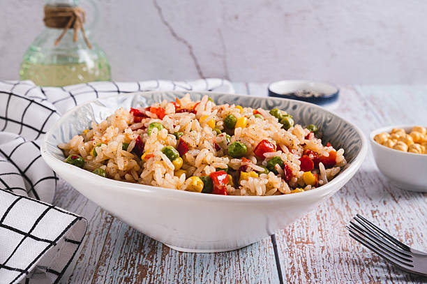 istock Homemade fried rice with peas, corn and pepper in a bowl on the table 2218484254