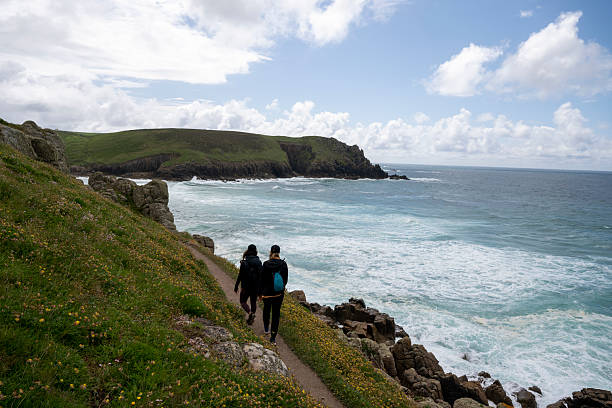 istock Young women hike pathway above ocean 2218484323