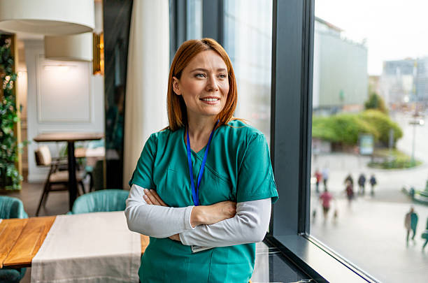 Smiling nurse looking out the window during break