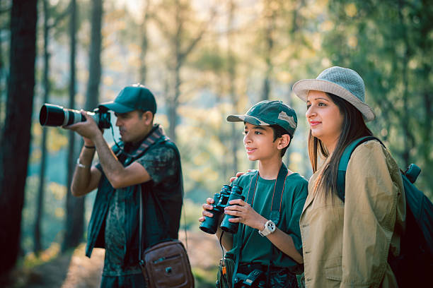 istock Family's birdwatching expedition in a sunlit forest. 2218486224
