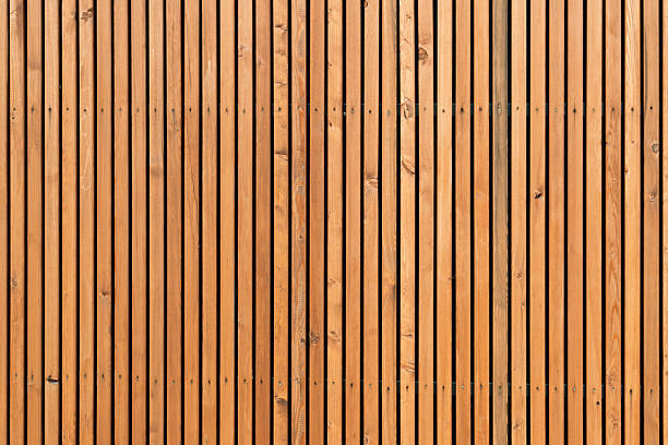 English: Vertical wooden planks create a rhythmic pattern, emphasizing natural texture and symmetry, perfect for modern architectural backgrounds.