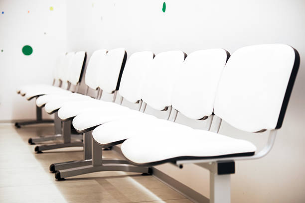 A row of chairs in a waiting room in the interior of building