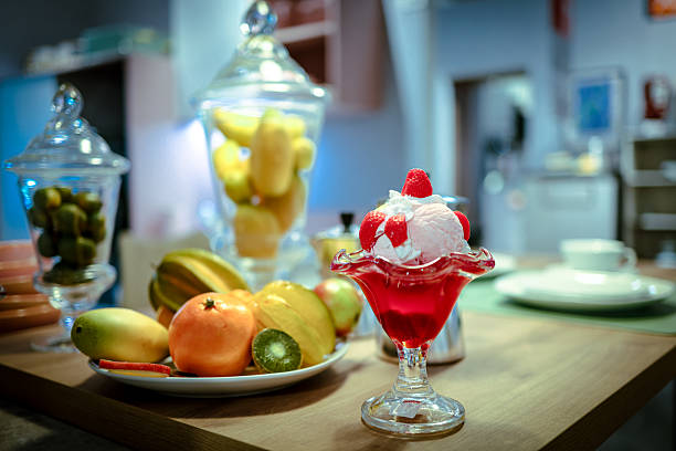 Fake fruit, dessert, ice cream still life in kitchen.