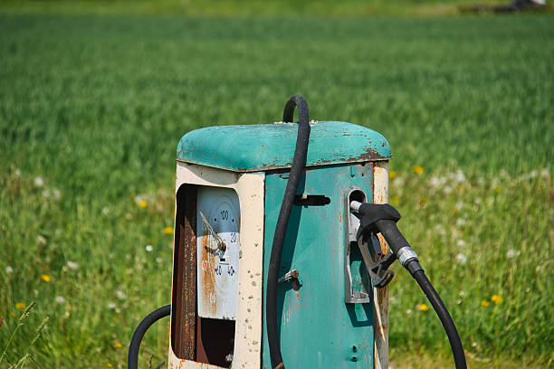 An old gas station fuel pump. Shallow depth of field. Sepia toned image, vintage processing.
