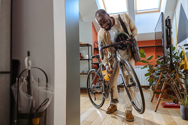 istock Man preparing bicycle gear in a modern living room 2218490071