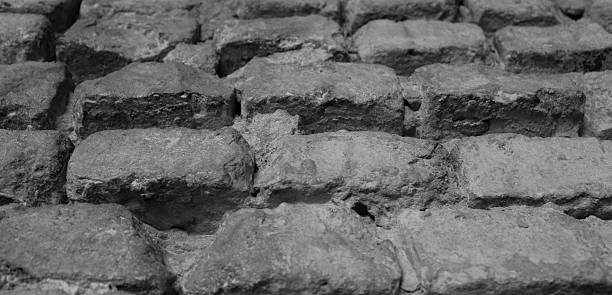 istock Sand mortar between old bricks of ancient masonry closeup view 2218494401