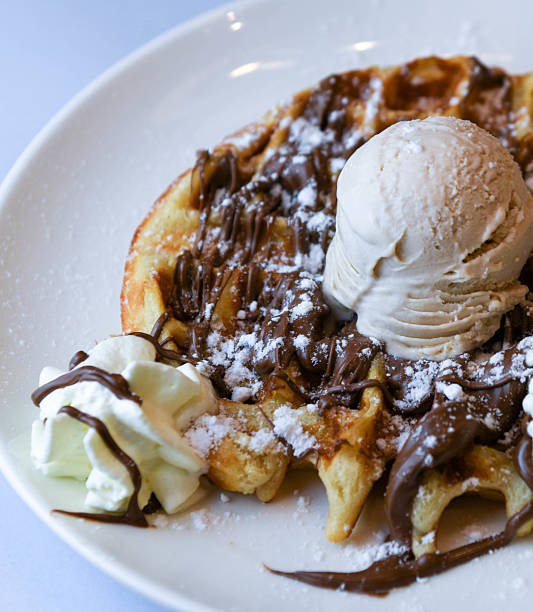 istock Belgian waffles with ice cream, chocolate syrup and whipped cream 2218495994