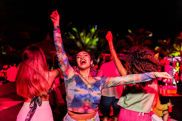 istock Young woman dancing during party outdoors 2218496421