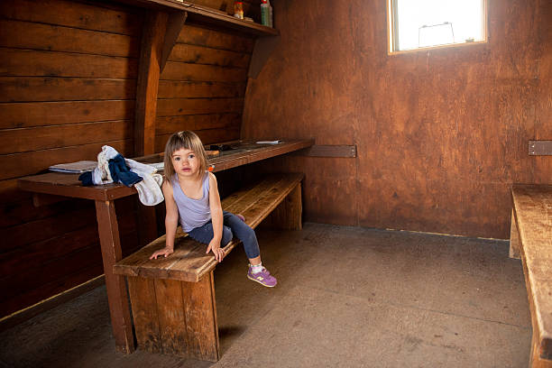 Little girl plays in mountain hut, on a backcountry hiking trip in summer, Whistler, British Columbia
