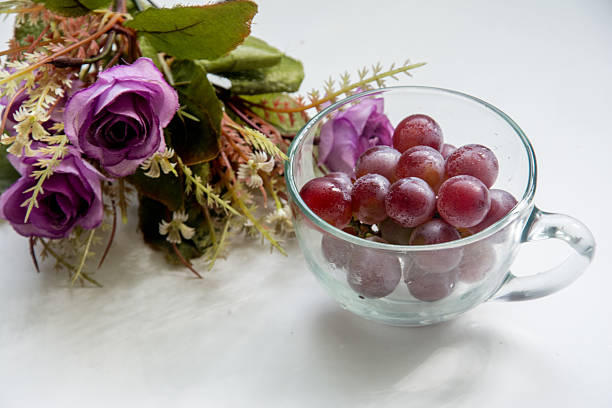 istock grapes in a glass cup on a white background 2218498681