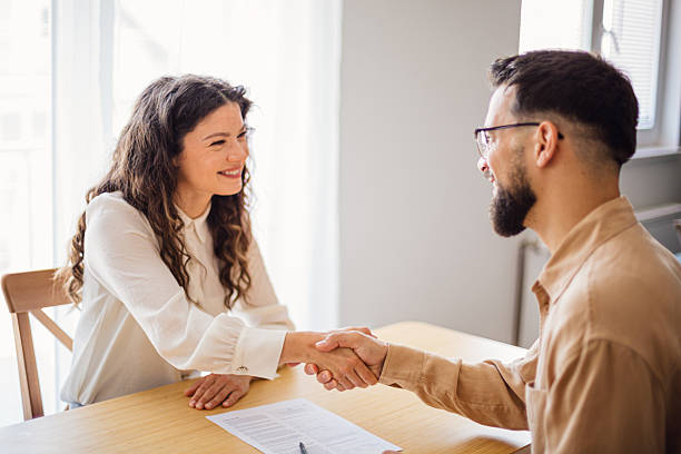 istock Smiling colleagues shaking hands in office meeting 2218499972