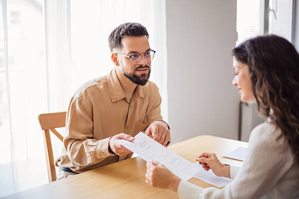 istock Financial advisor showing contract to client during a meeting 2218500521