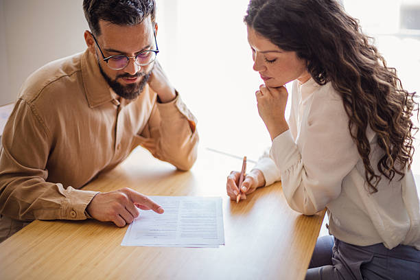 Colleagues reading and discussing a document at the office