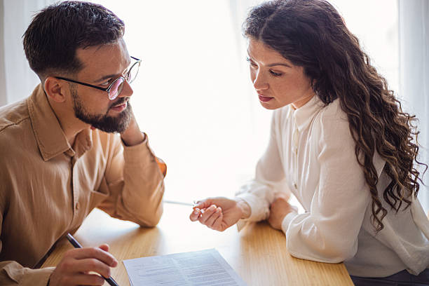 istock Couple reading and discussing a contract at home 2218501318
