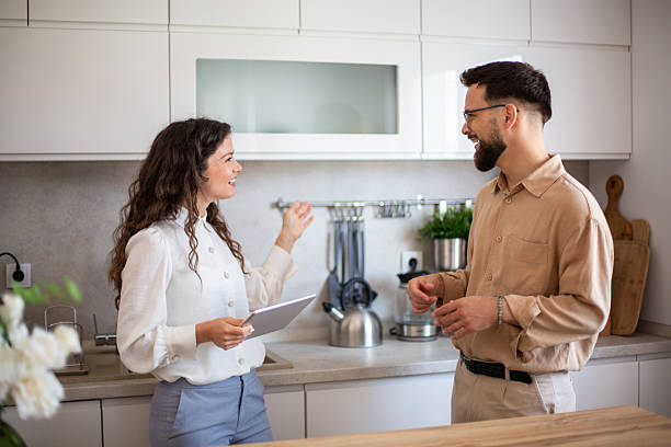 istock Interior designer showing digital tablet to client in modern kitchen 2218501931