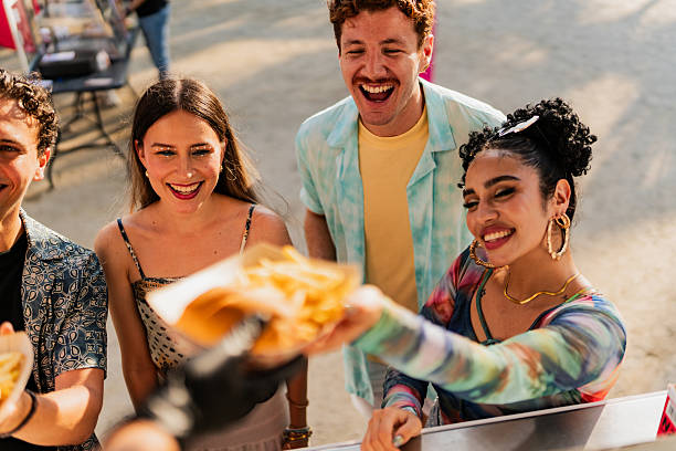 istock Young friends buying snacks outdoors 2218502085