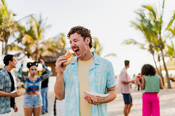 istock Young man eating snack outdoors 2218502160