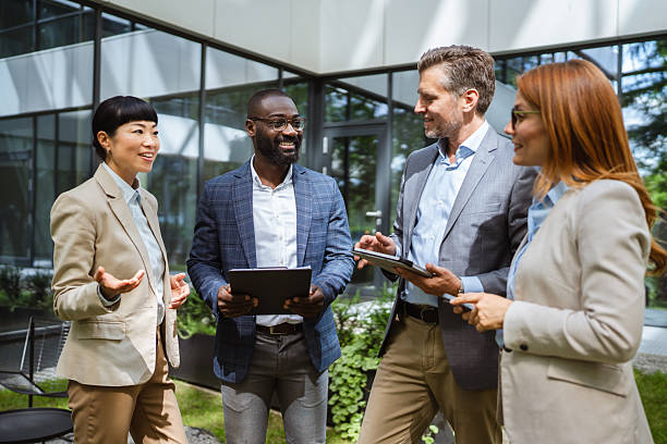 istock happy multiracial entrepreneurs businesspeople communicating 2218504409