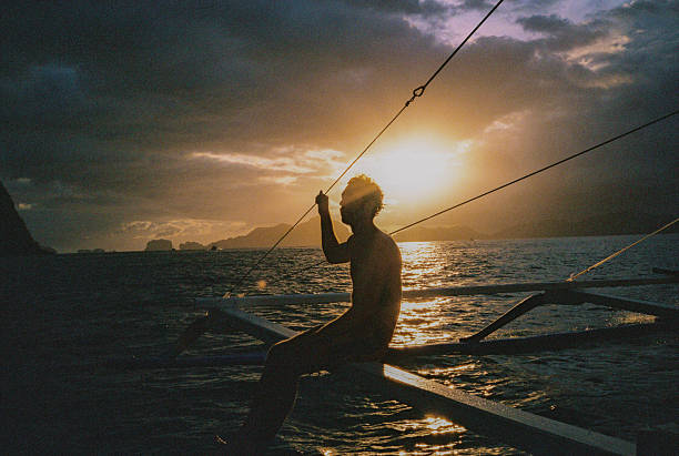 Man traveling by boat between islands on the Philippines. Shot on camera film during experiential adventurous trip