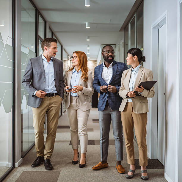 istock multicultural colleagues have informal meeting at company hallway 2218504898