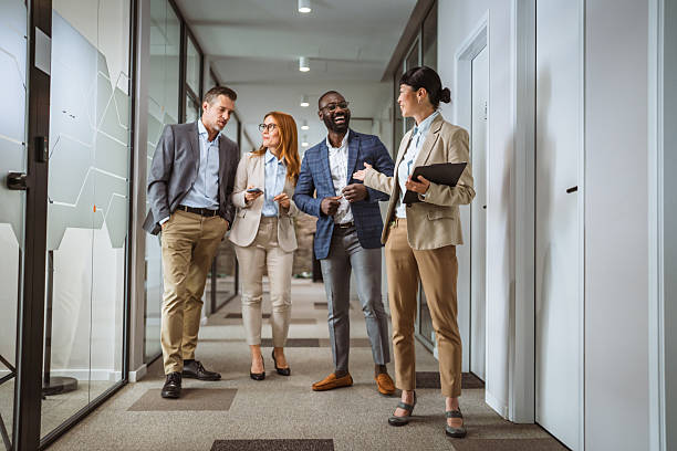 istock multicultural colleagues have informal meeting at company hallway 2218504899
